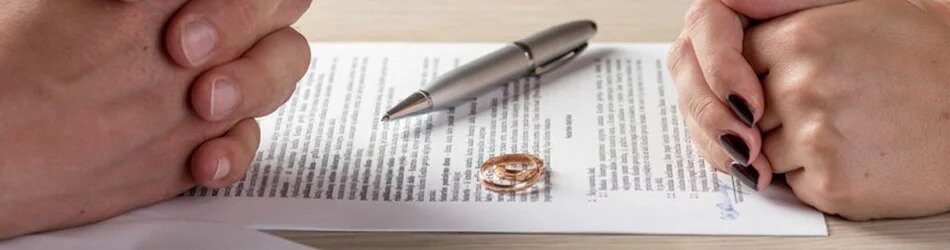 Divorce paperwork with wedding rings laying on top