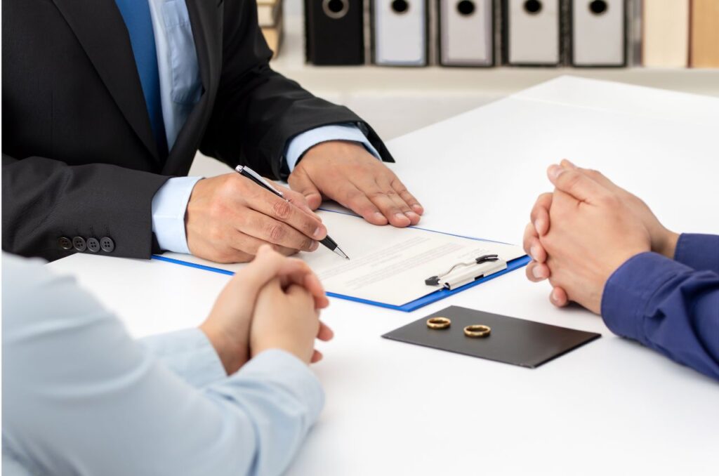 Couple sitting at table with rings on paper