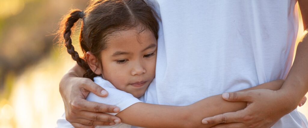 father hugging his daughter