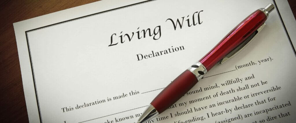 Pen laying on top paper document that reads living will