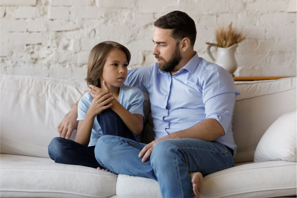 Father sitting on a couch with his son