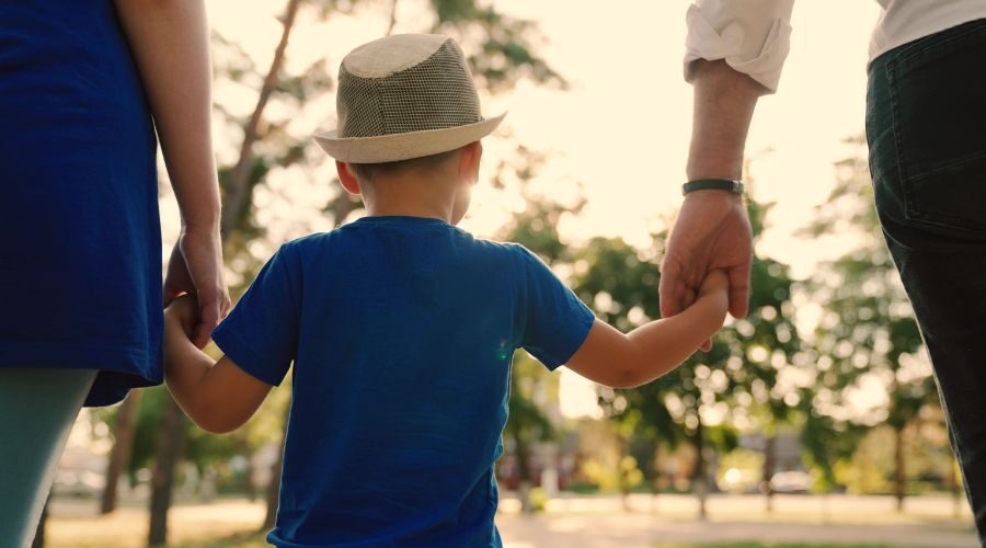 Father and mother holding hands with their son