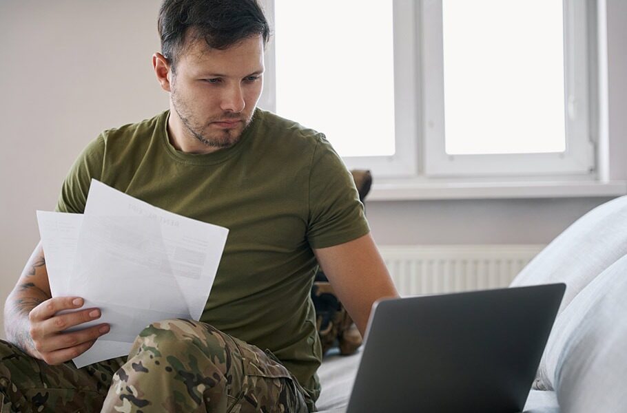 man wearing military fatigues filling out paperwork