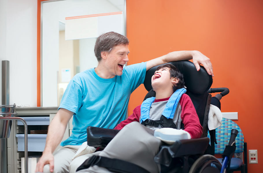 a dad and his special needs son laughing