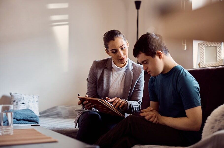 A mother reviewing paperwork with her special needs son 