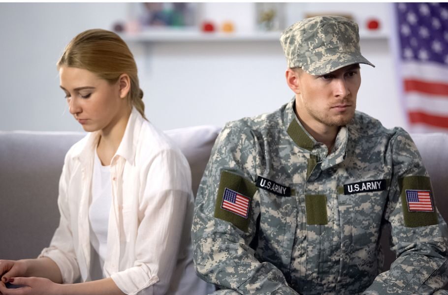military couple sitting together looking upset