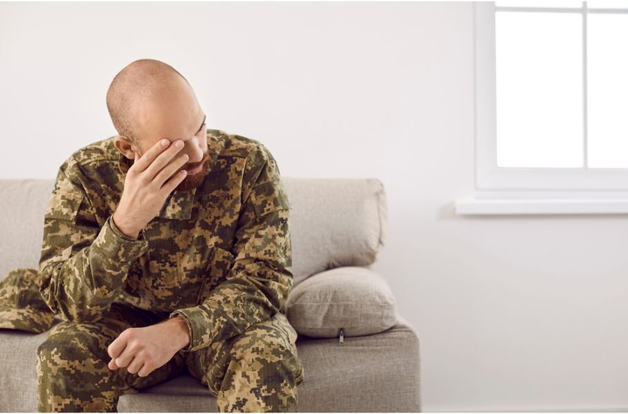soldier holding his head in grief