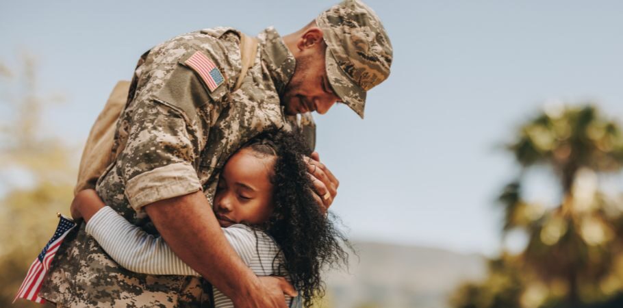 military father hugging his daughter