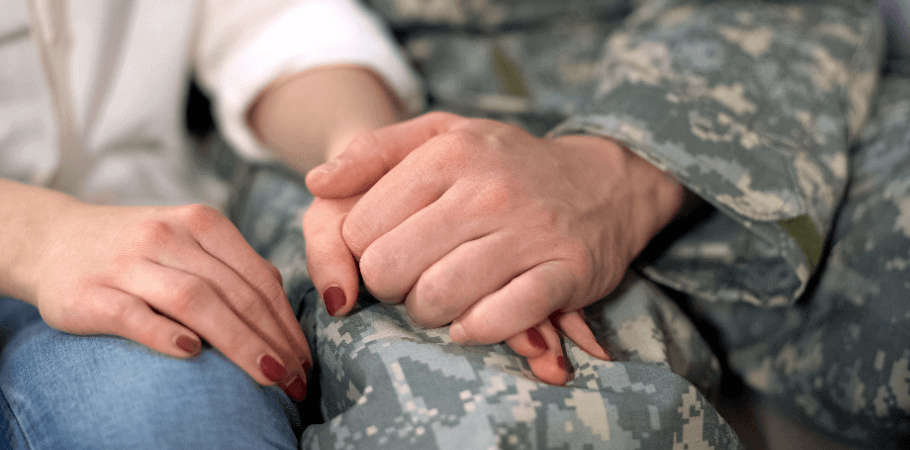 military service member holding his spouses hand
