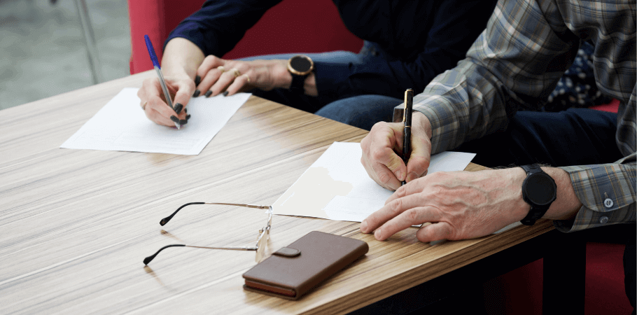 elderly couple signing paperwork