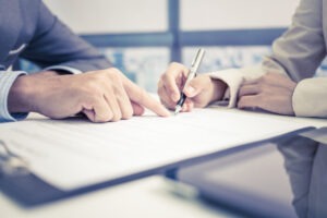 A modifications lawyer reviewing documents with a client.