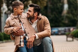 A dad picking up a child from a party.