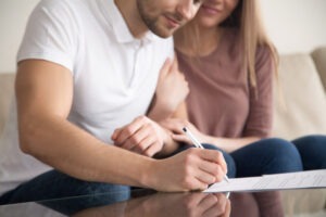 A couple signing their prenuptial agreement. Feel confident about the foundation of your marriage with a Tampa prenuptial agreement lawyer.