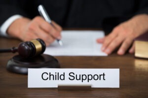 A judge behind a child support sign. Get professional help today from a child support attorney