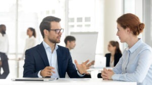 A trusts and estates lawyer in Fairfax, sitting with their client, discussing legal options.