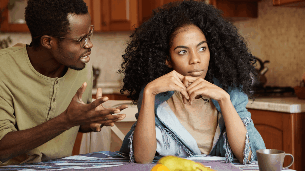 Couple arguing at kitchen table