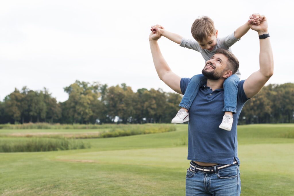 Father holding son on shoulders