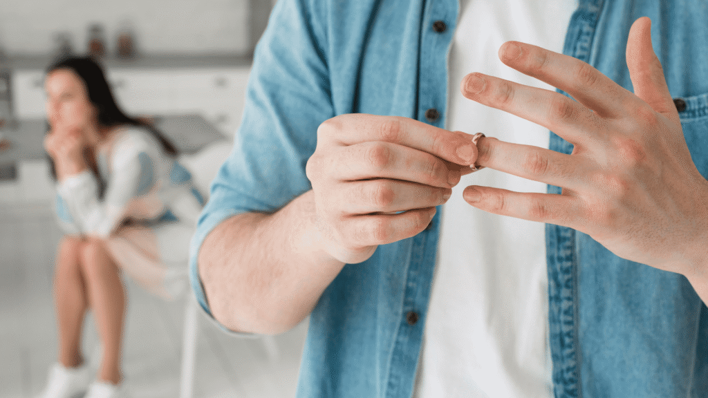 Close-up of man removing wedding ring