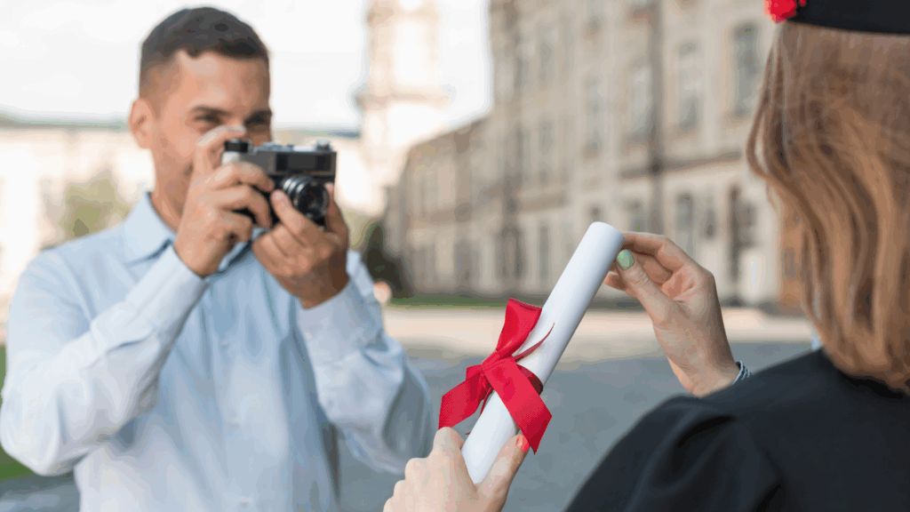 Father taking photo of daughter graduating with diploma in hand