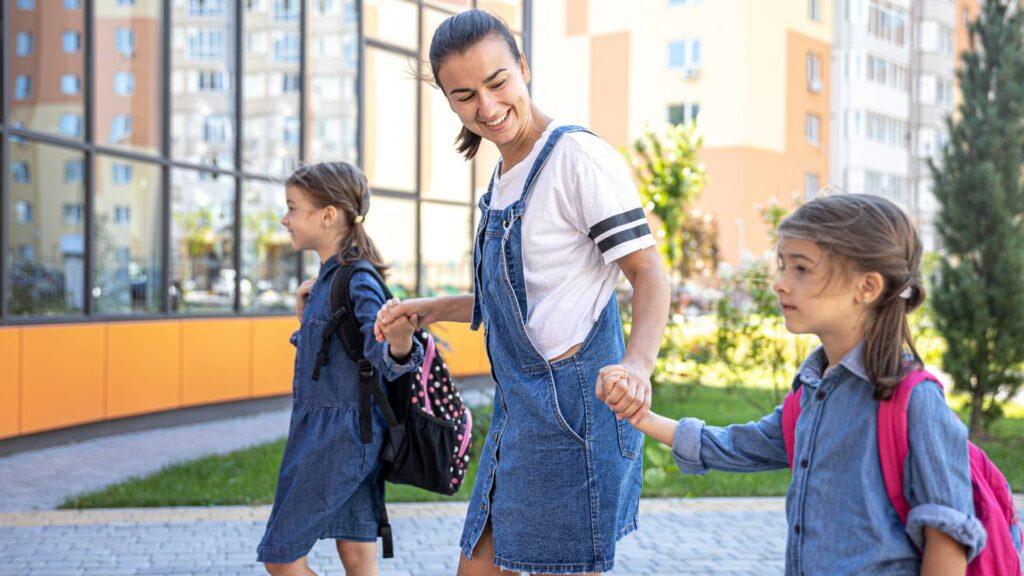 Divorced mother walking her two children to school
