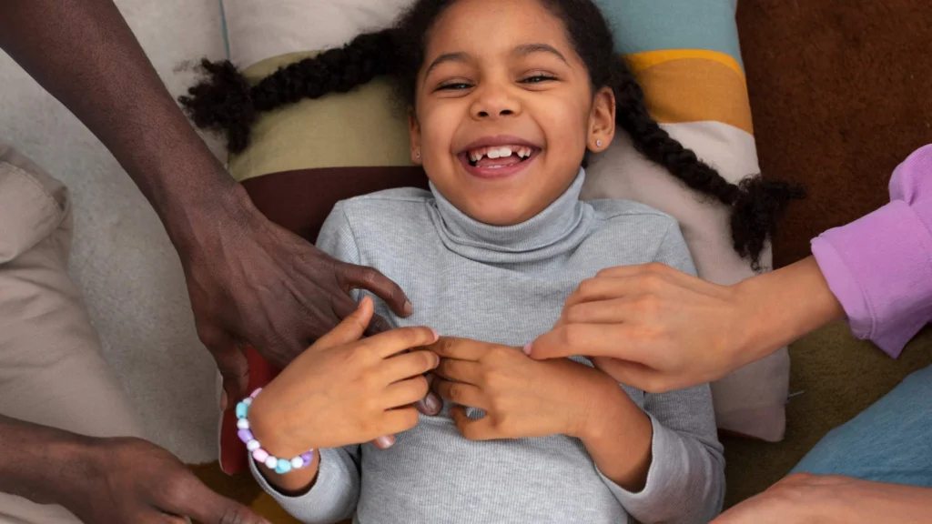 Child smiling holding parents hands