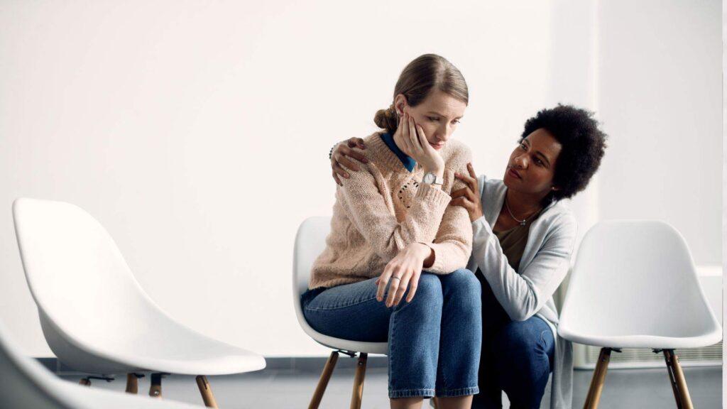 Adult comforting teen girl