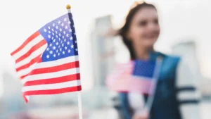 An American flag and a woman holding an American flag